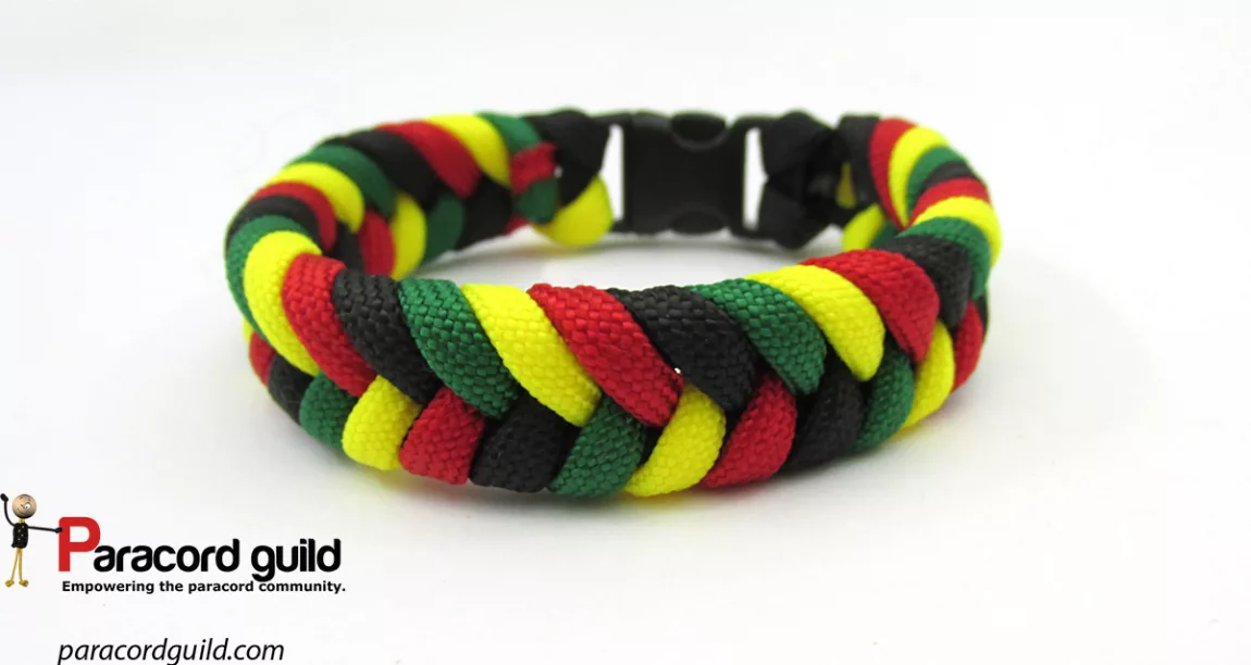 rastaparacordbracelet Explore Magazine Multicolor braided paracord bracelet (red, yellow, green, black) with black buckle on white background; Paracord Guild logo in corner.