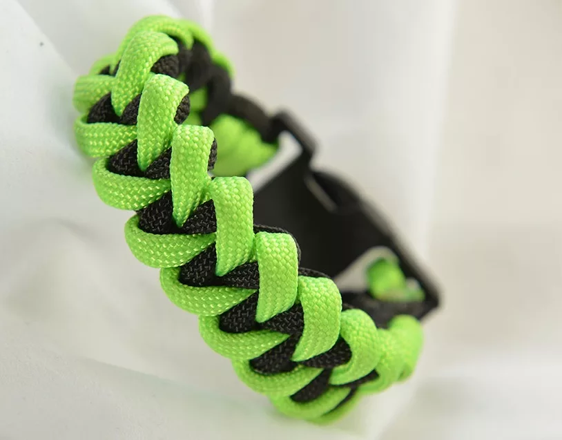 sharkjawboneparacordbracelet Explore Magazine Neon green and black paracord bracelet woven in a chunky cobra knot style.