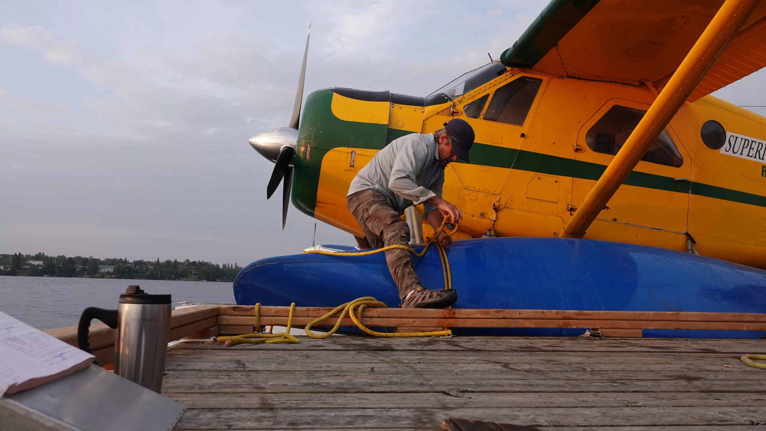 Man untying ropes from a bush plane