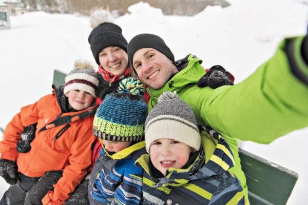 A family and child spending time outdoor in winter