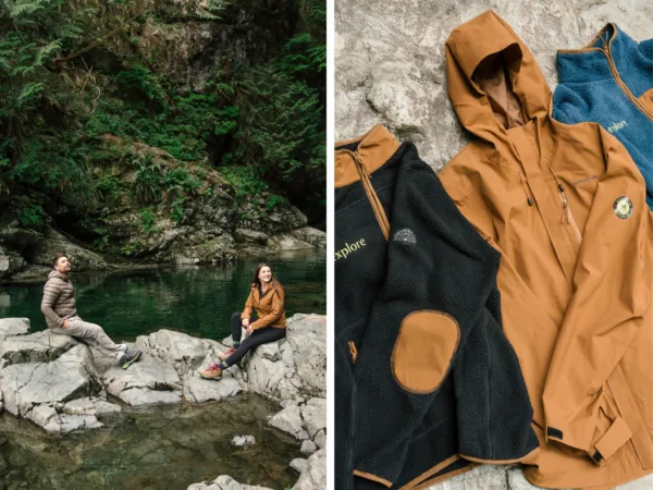 Split-photo: left panel shows a man and a woman in outdoor jackets sitting on rocks by a calm river with a forested backdrop; right panel displays tan outdoor jackets and black fleece laid out on a rocky surface.